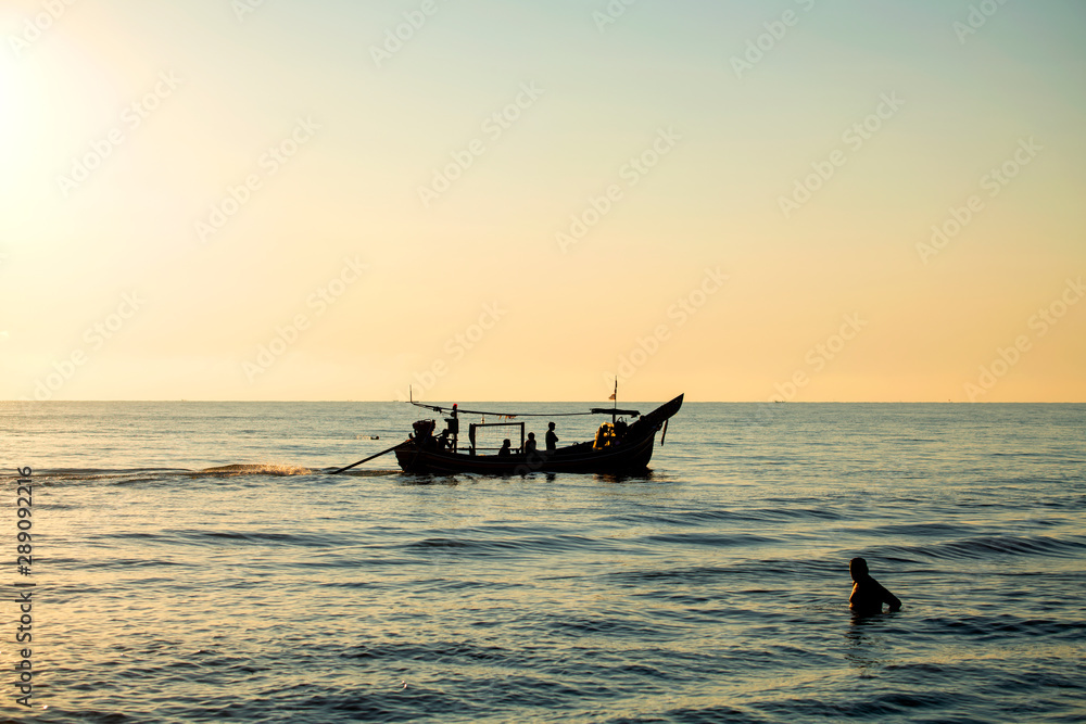 Local fishing boats fish in the sea, morning sunrise with beautiful light