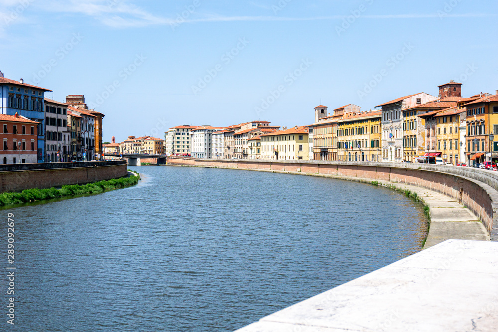 View of the Arno river and colorful, beautiful buildings in Pisa,Tuscany, Italy