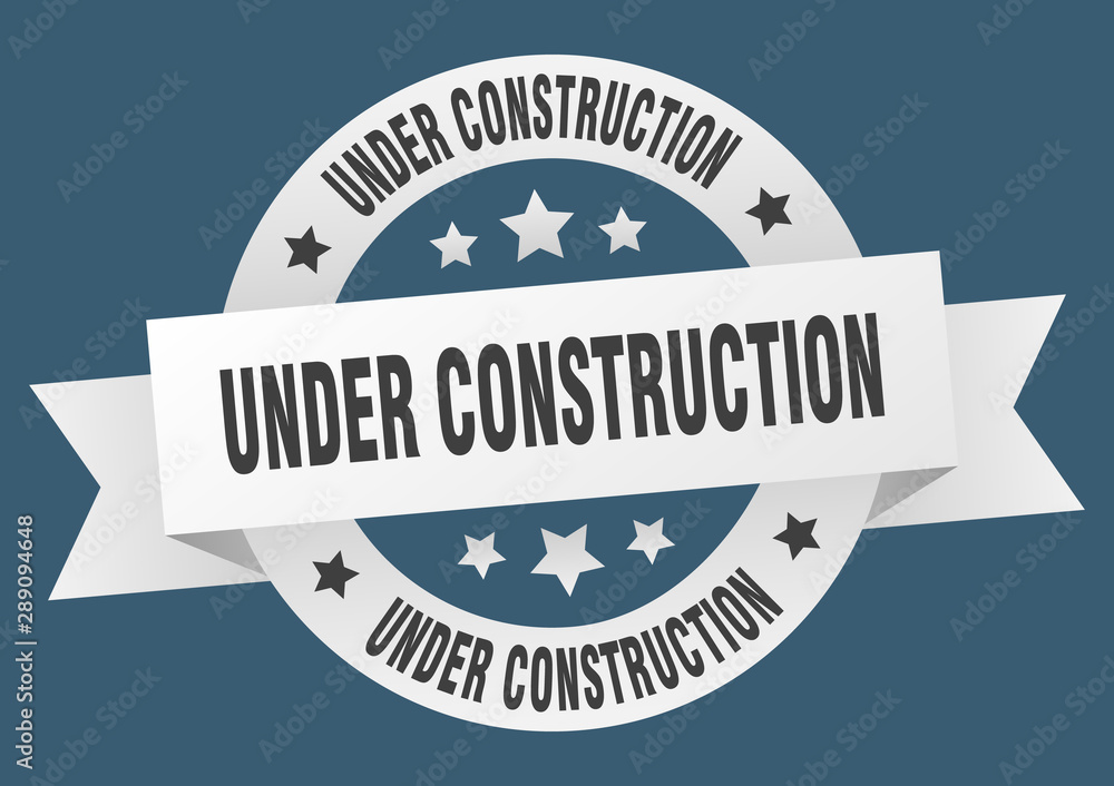 Obraz premium under construction ribbon. under construction round white sign. under construction