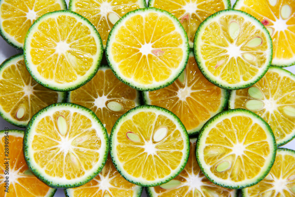 round slices of natural fresh tangerines, oranges, lemon, lime with green peel round slices of natural fresh tangerines, oranges, lemon, lime with green peel