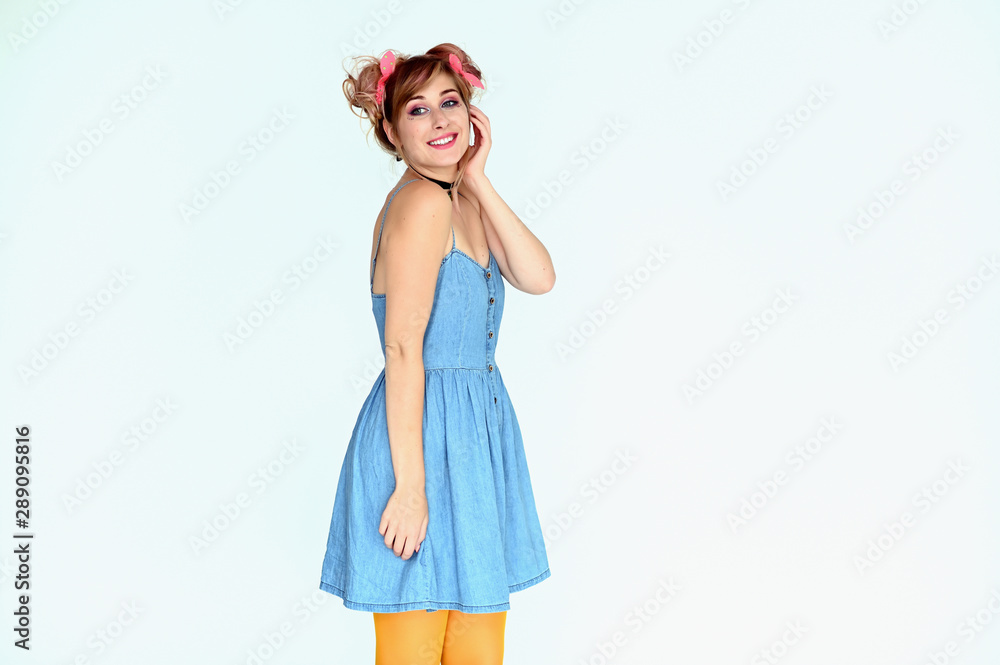 Portrait of a cute happy funny blonde girl with colored hair in a funny dress on a white background. Smiling in various poses, beauty, holiday. Portrait of a cute happy funny blonde girl with colored hair in a funny dress on a white background. Smiling in various poses, beauty, holiday.