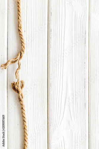 rope frame on white wooden background top view mock up