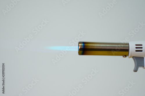 gas flame gun torch blue fire butane white background