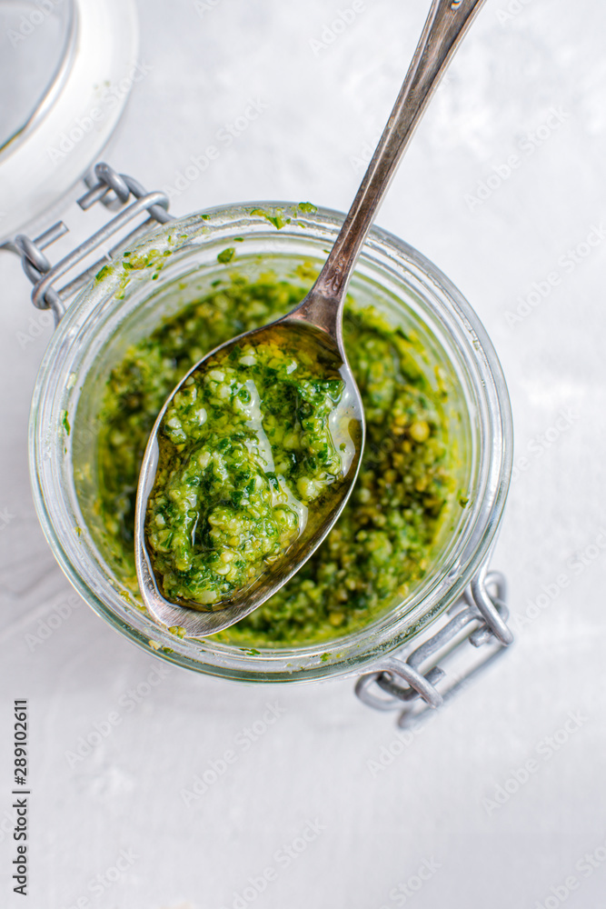 Glass jar with pesto sauce, top view Glass jar with pesto sauce, top view