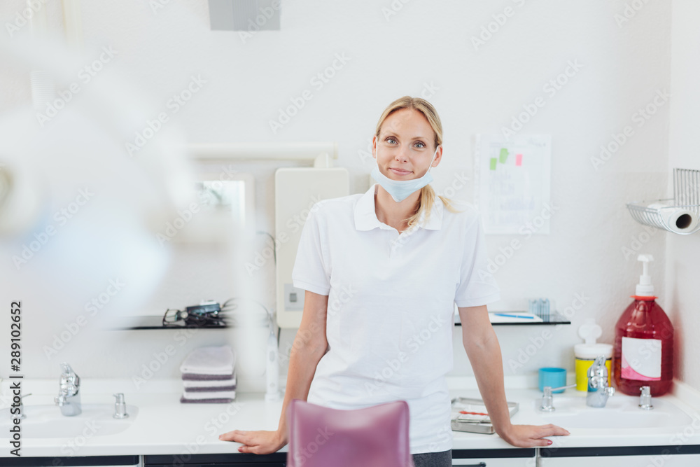 Friendly young female dental assistant Friendly young female dental assistant