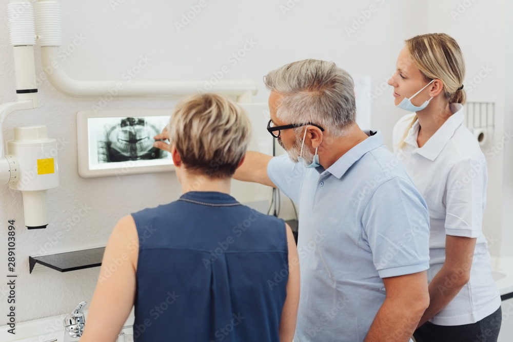 Dentist explaining options to a female patient Dentist explaining options to a female patient