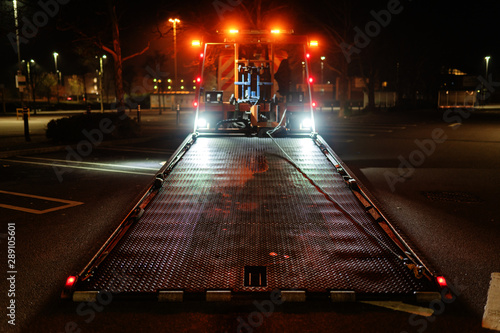 Wallpaper Mural London,UK - March 17, 2019: rescue service truck carrying a saloon car BMW 7 series Torontodigital.ca