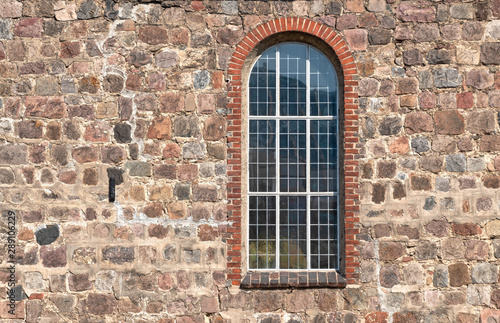 Old stone wall with a window