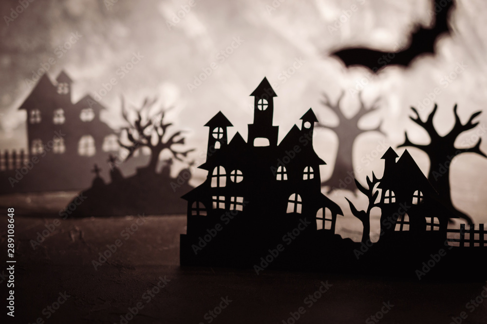 Mysterious night landscape with houses silhouettes and graveyard Template for design with space for text.