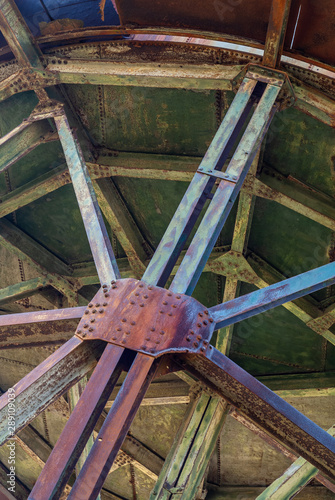 Louzal or Lousal pyrite Mine in Portugal, view of the rusty vintage water tank structure in the abandoned railway station. photo