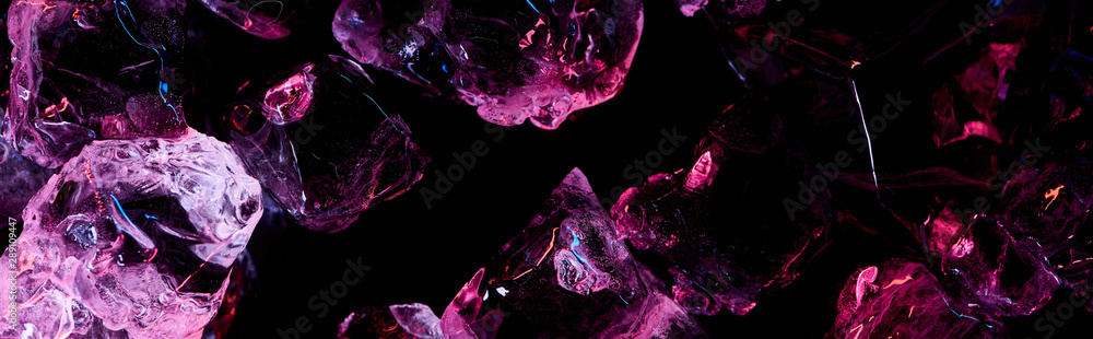 panoramic shot of transparent ice cubes with purple light isolated on black panoramic shot of transparent ice cubes with purple light isolated on black