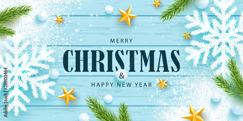 Merry Christmas and Happy New Year horizontal banner. Holiday background with sparkling snowflakes,tree branches, golden stars, snowballs and snow on a wooden background. Festive vector illustration.