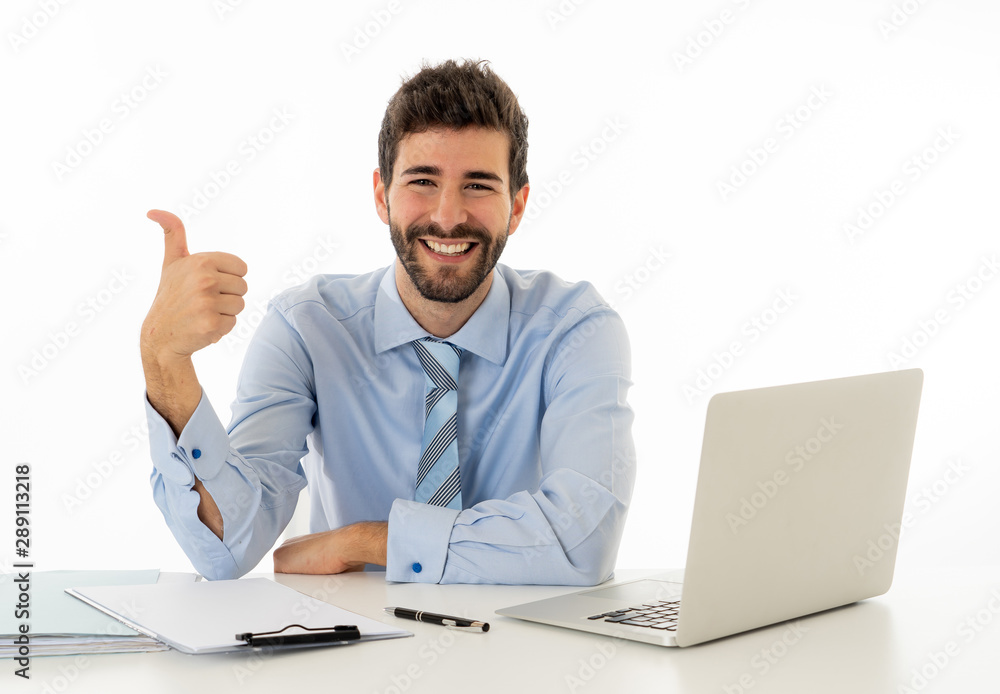 Attractive happy Young caucasian businessman working on laptop computer feeling successful at work Attractive happy Young caucasian businessman working on laptop computer feeling successful at work
