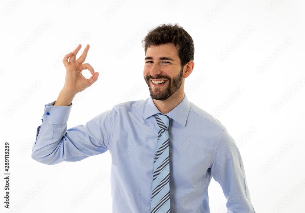 Portrait of young attractive businessman smiling and doing all OK sign Isolated on white background Portrait of young attractive businessman smiling and doing all OK sign Isolated on white background