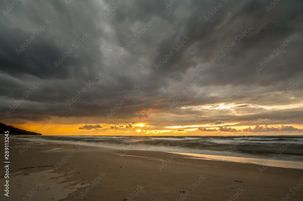 A stormy and dramatic sunrise over the sea. Nature composition. Concept: vacation or weather