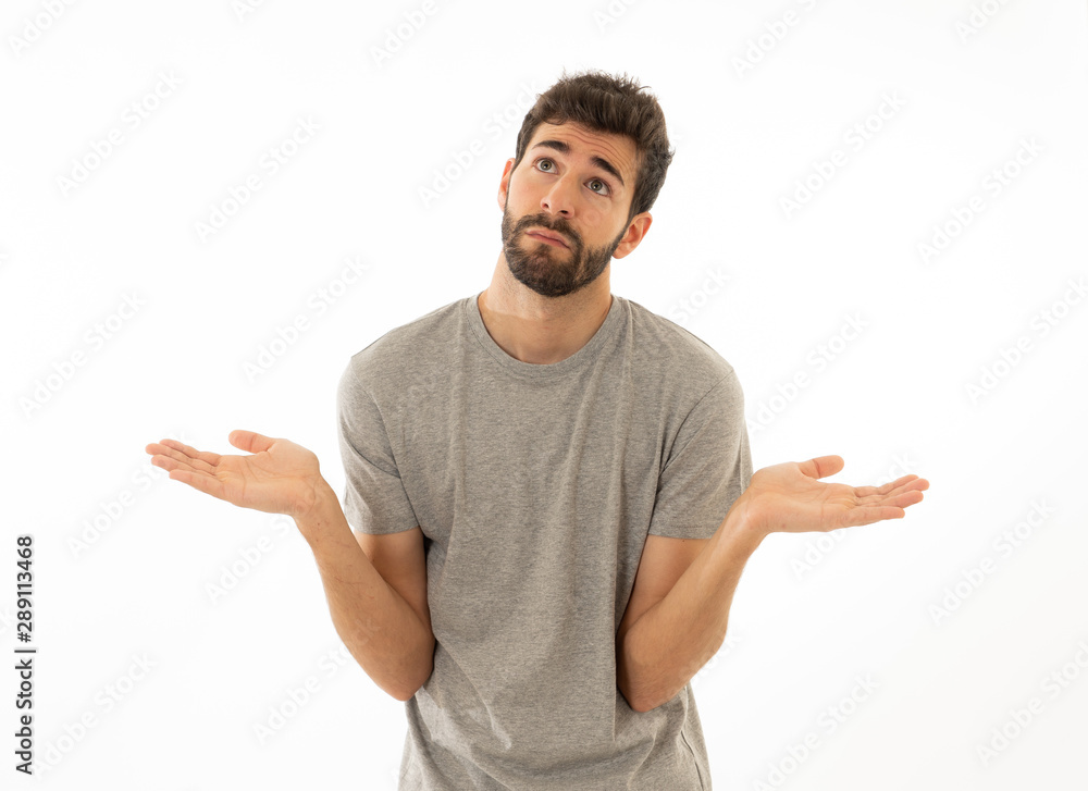 Good looking man with no idea, oops sorry or I do not care gesture smiling at the camera Good looking man with no idea, oops sorry or I do not care gesture smiling at the camera
