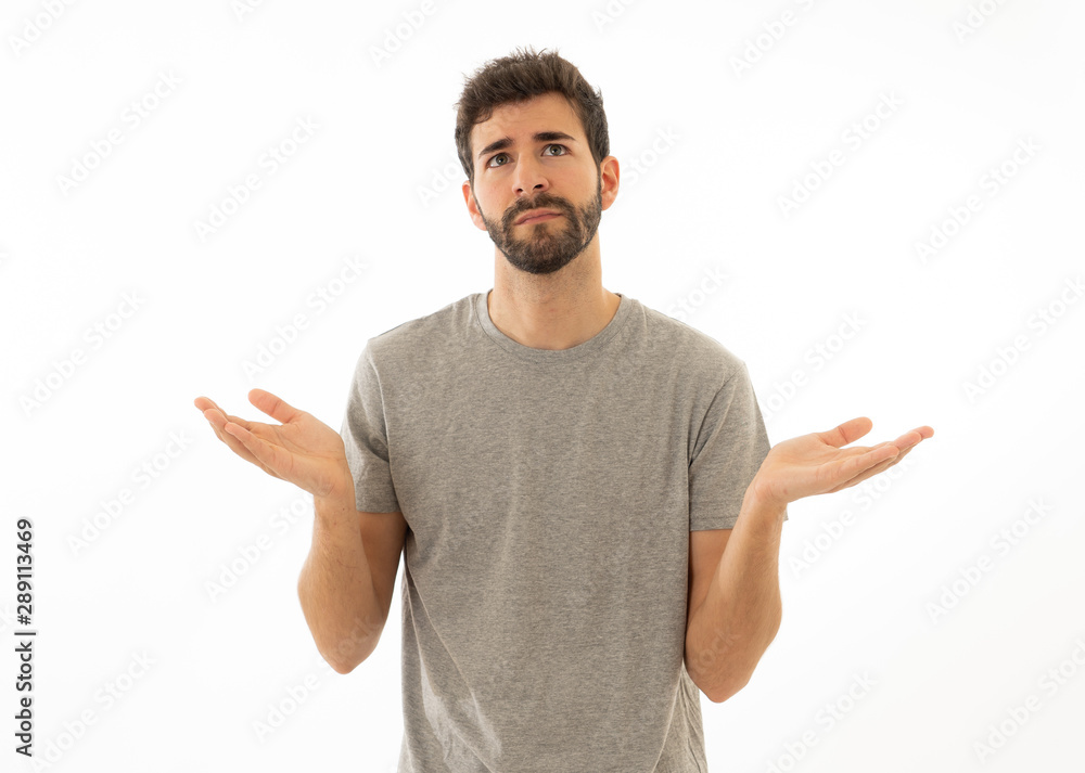 Good looking man with no idea, oops sorry or I do not care gesture smiling at the camera Good looking man with no idea, oops sorry or I do not care gesture smiling at the camera