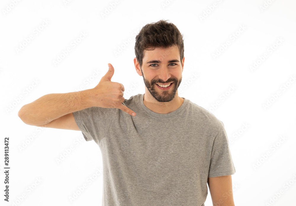 Handsome young man showing Call Me gesture smiling and looking at the camera hand as mobile phone Handsome young man showing Call Me gesture smiling and looking at the camera hand as mobile phone