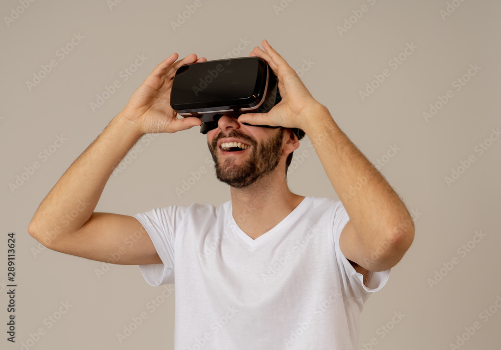 Portrait of excited and amazed young man wearing Virtual Reality headset exploring 3D world Portrait of excited and amazed young man wearing Virtual Reality headset exploring 3D world