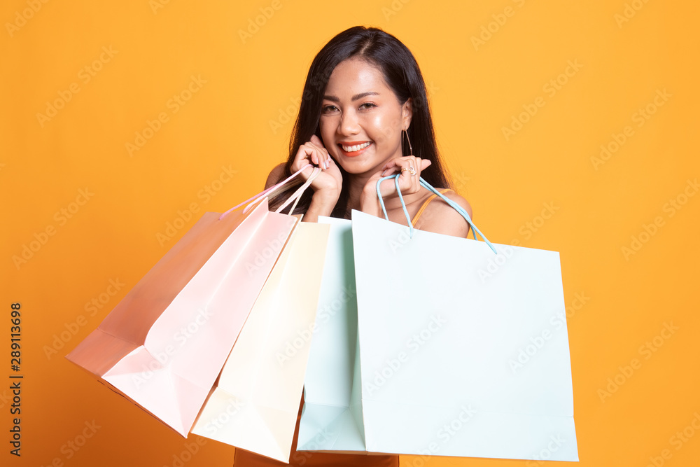 Beautiful young Asian woman with shopping bags. Beautiful young Asian woman with shopping bags.
