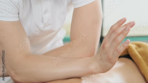 Wallpaper Mural Male masseur doing massage. Young woman receiving oil massage in spa salon. Close-up view in slow motion. Body relaxation and skin care Torontodigital.ca