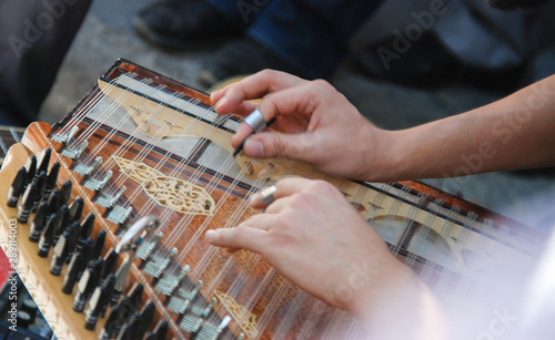 Playing Turkish Qanun Musical Instrument. Selective focus.