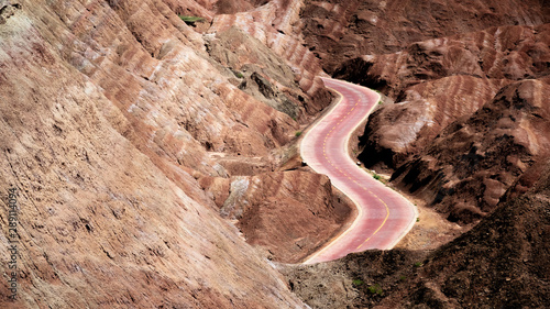 Curvy road through the colorful rainbow mountains. China landscape on the silk route. Zhangye Danxia National geological park, Gansu Province.  photo