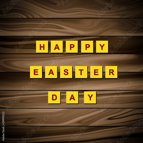 Happy Easter Day written on a yellow paper isolated on a wooden plank.