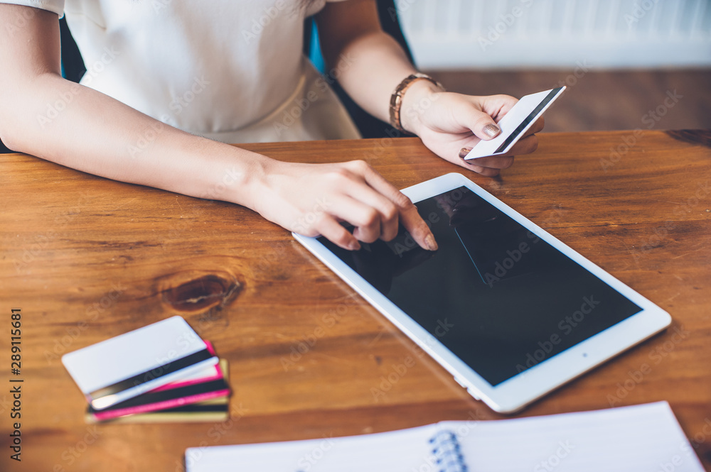 Women are shopping online with a tablet using a credit card. Women are shopping online with a tablet using a credit card.