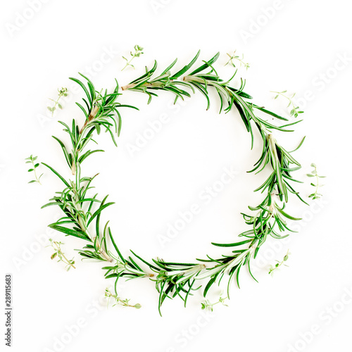 Round wreath frame made of mix of herbs  green branches  leaves rosemary and thyme. Set of medicinal herbs. Flat lay. Top view.