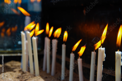 Perspective of Many candle flame on a black background.