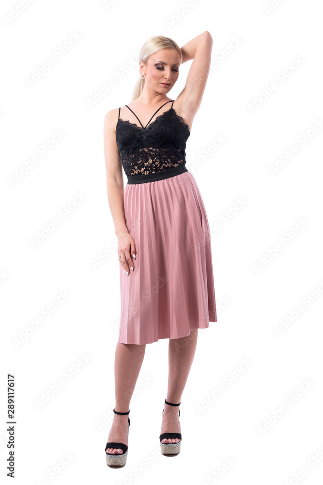 Sexy fashion blond hair woman looking down and posing with hand in hair. Full body isolated on white background. Sexy fashion blond hair woman looking down and posing with hand in hair. Full body isolated on white background.