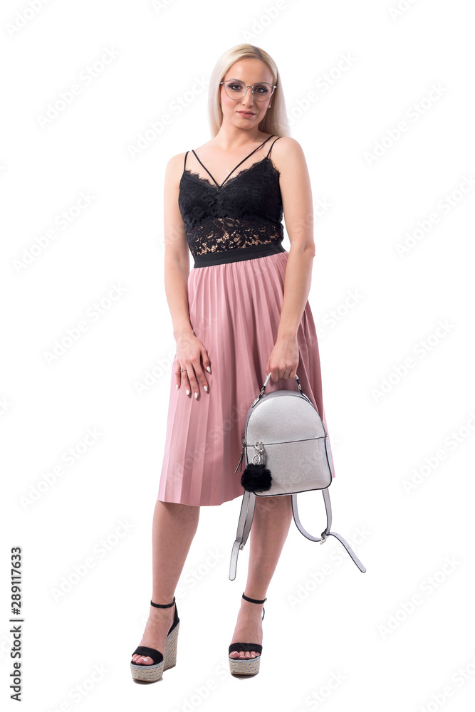 Confident young blond woman in modern fashion style carrying gray trendy bag. Full body isolated on white background. Confident young blond woman in modern fashion style carrying gray trendy bag. Full body isolated on white background.