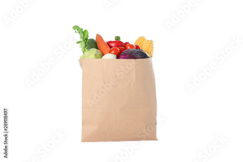 Paper bag with different vegetables isolated on white background