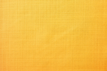 Golden yellow linen fabric texture background with fine natural weave pattern