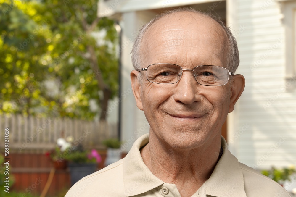 Handsome senior man standing on the house background Handsome senior man standing on the house background