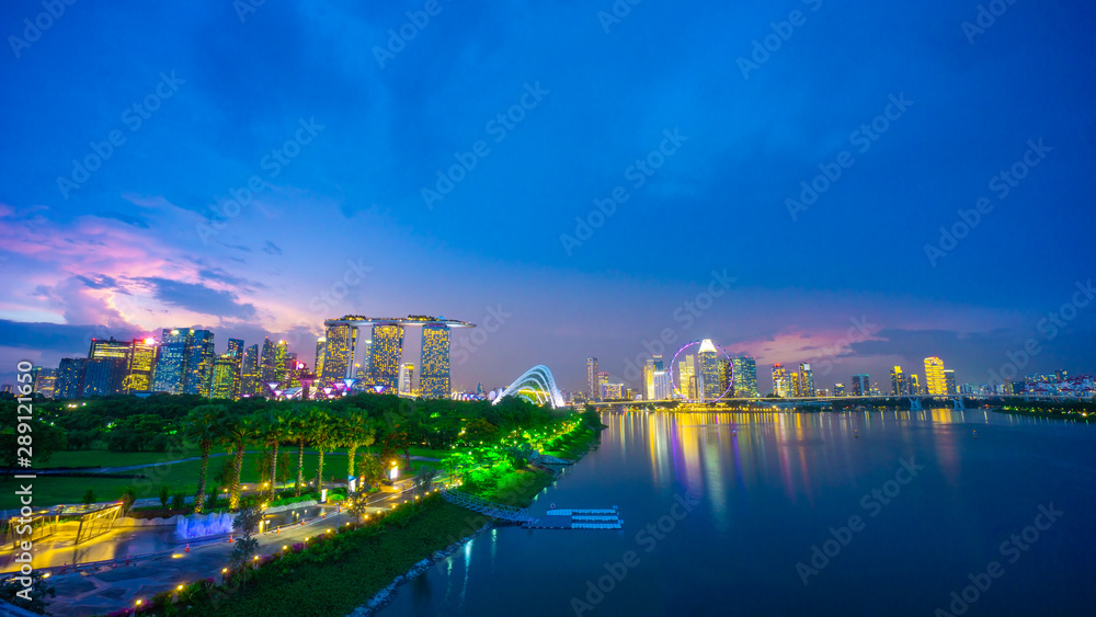 Landscape of Singapore city during the twilight time with marina bay sand tower, and Singapore flyer and Gardens by the Bay background. Tourist Landscape of Singapore city during the twilight time with marina bay sand tower, and Singapore flyer and Gardens by the Bay background. Tourist