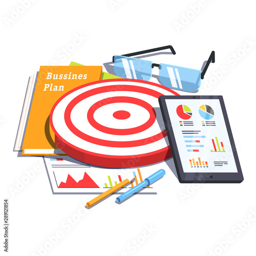 Business plan document next to analytics report