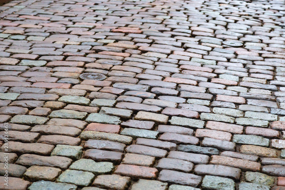 Cobblestone road. Texture of  stone. Background with stones. Selective focus.