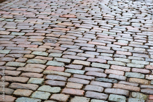 Cobblestone road. Texture of stone. Background with stones. Selective focus.