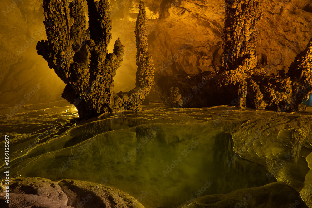 Nguom Ngao cave in North Vietnam, Cao Bang province. Enormous stalagmites  and reflecting water pools. Vietnamese landscape. Stock Photo | Adobe Stock