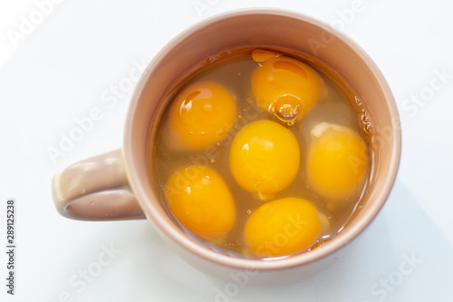 egg yolks in bowl on white background
