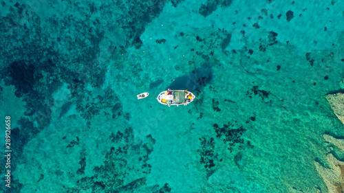 Aerial drone photo of picturesque and traditional colourful fishing boat docked in port of Koufonisi island, Small Cyclades, Greece