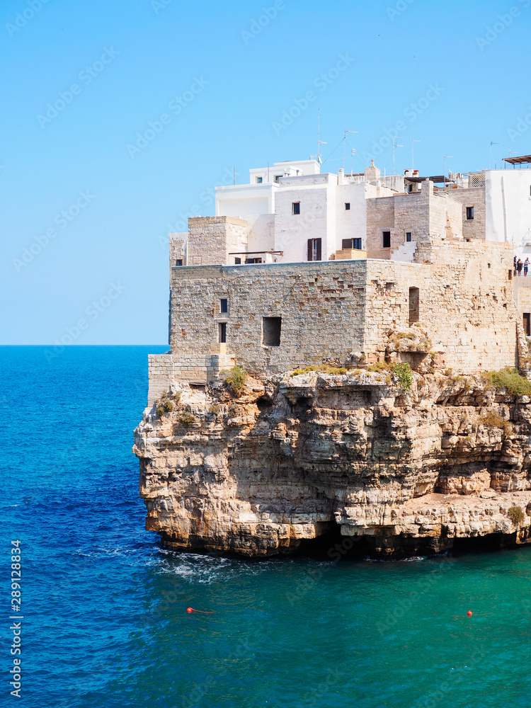 Polignano a mare coast in Bari, Italy during summer with turquoise blue water in the sea.