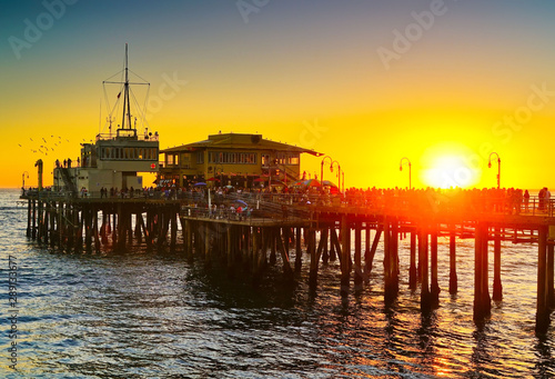 View of Santa Monica Pier on the beach at sunset.
