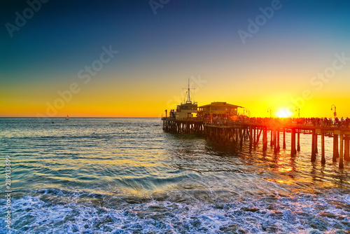 View of Santa Monica Pier on the beach at sunset. photo