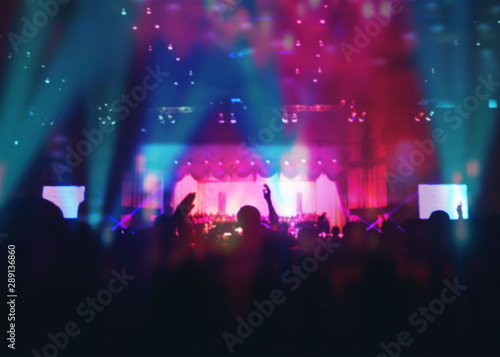 Blurred of Christian Congregation Worship God together in Big Church hall in front of music stage and light effected.