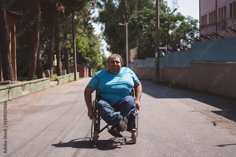 Obraz premium disabled man in wheelchair on road