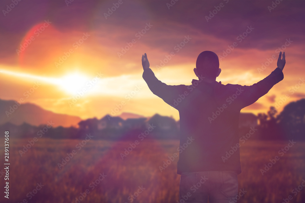 soft focus and Silhouettes of man raise hand up worship God against blurred sunset sky . Christian background with copy space for your text soft focus and Silhouettes of man raise hand up worship God against blurred sunset sky . Christian background with copy space for your text