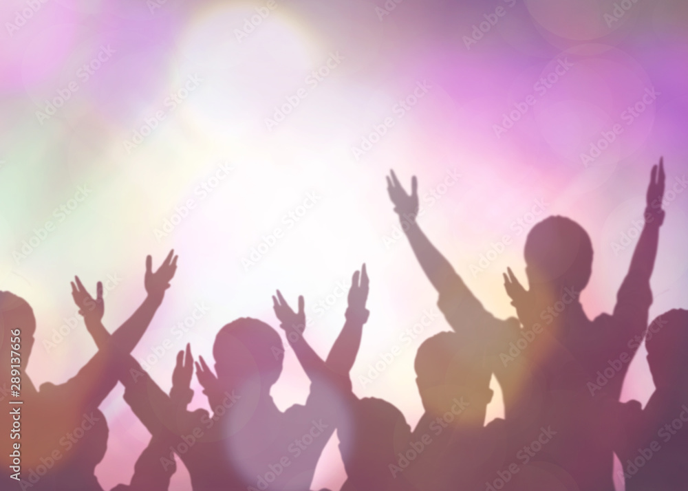 soft focus of christian people group raise hands up worship God Jesus Christ together in church revival meeting with blurred music concert light background can be used for Christian worship background